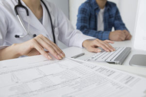doctor reviews medical records with a patient