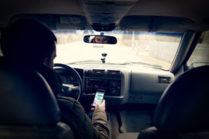 driver looking down at phone instead of watching road