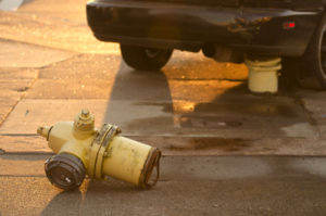 broken fire hydrant in the road