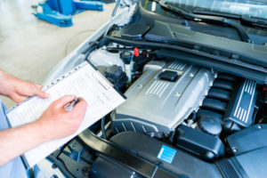 mechanic-taking-notes-on-a-vehicle’s-defects