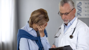 doctor giving female patient a bad test result