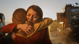 two injured women hug after accident